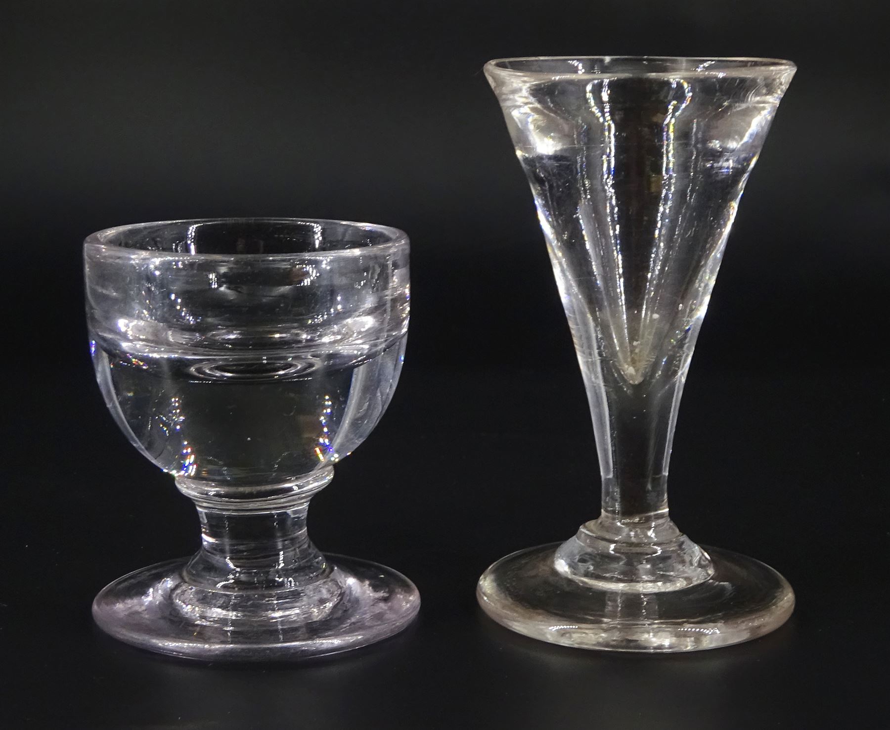 19th century toastmasters glass, the trumpet bowl upon firing type foot, H10cm, together with a further 19th century toastmasters/ penny lick type glass with deceptive rounded bowl upon firing type foot, H7cm