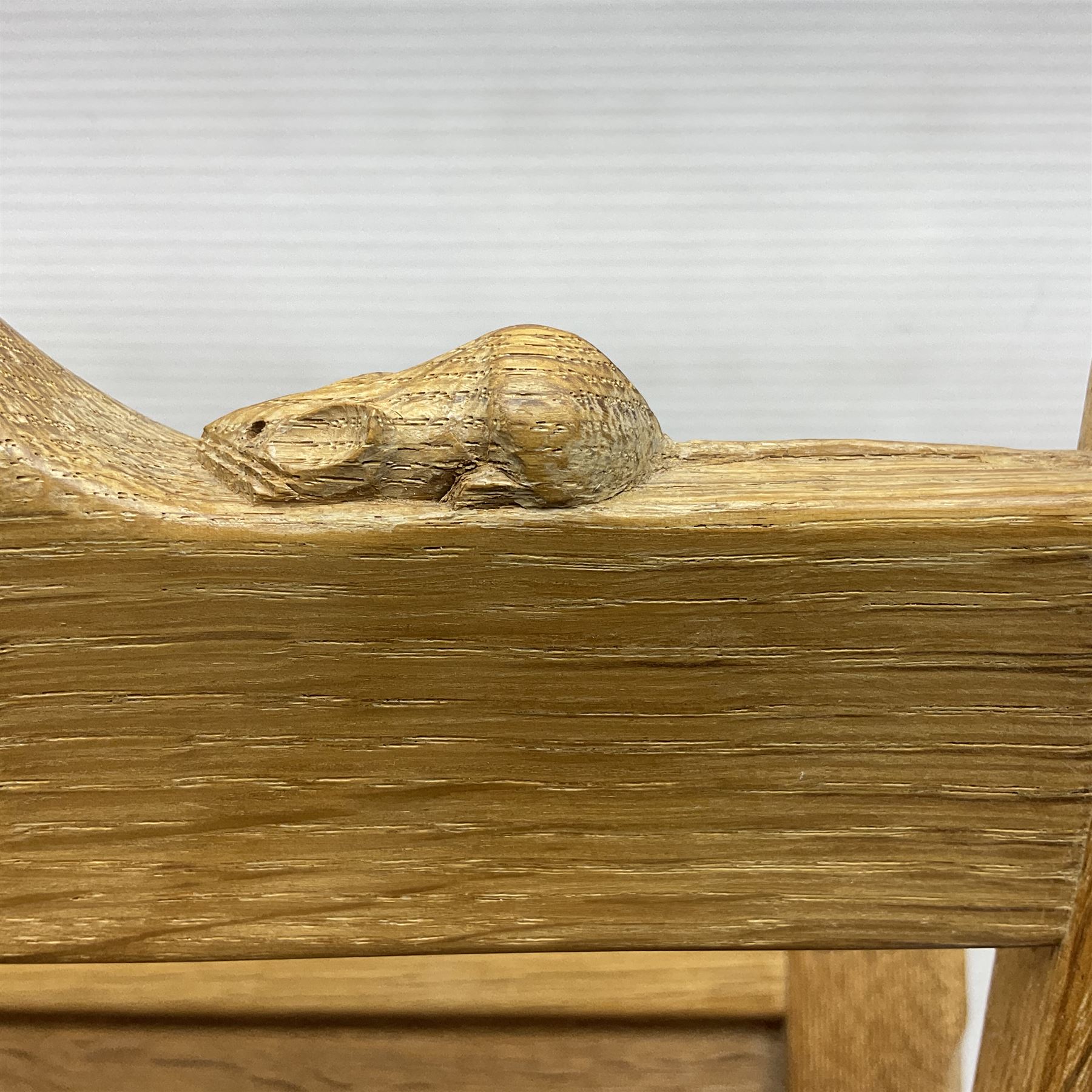 Mouseman - oak magazine rack, the top rail pierced with handle and carved with mouse signature, octagonal supports with two panelled and splayed sides, on sledge feet, by the workshop of Robert Thompson, Kilburn 