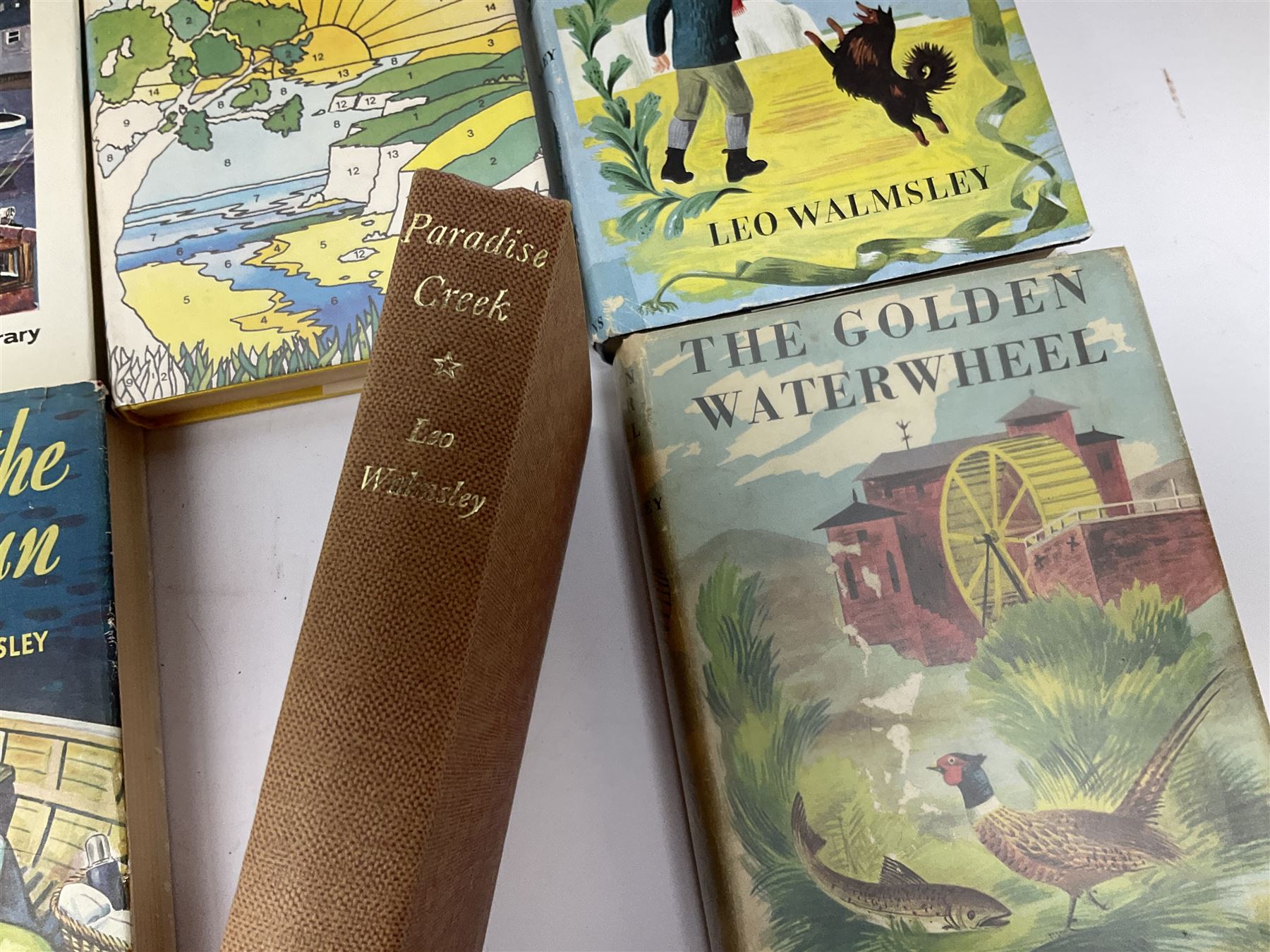 Leo Walmsley: a collection of Novels mostly 1st ed. including Phantom Lobster, signed by the author, Love in the Sun, The Happy Ending, Angler's Moon, Sally Lunn, The Silver Blimp, Love in the Sun, Paradise Creek, Fishermen at War, Golden Waterwheel, Sound of the Sea, etc (16)