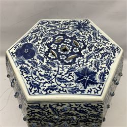 Chinese blue and white garden seat, of hexagonal barrel form, profusely decorated with flower heads and scrolling foliate vines above a lower stiff leaf border, seat D27cm overall H46.5cm