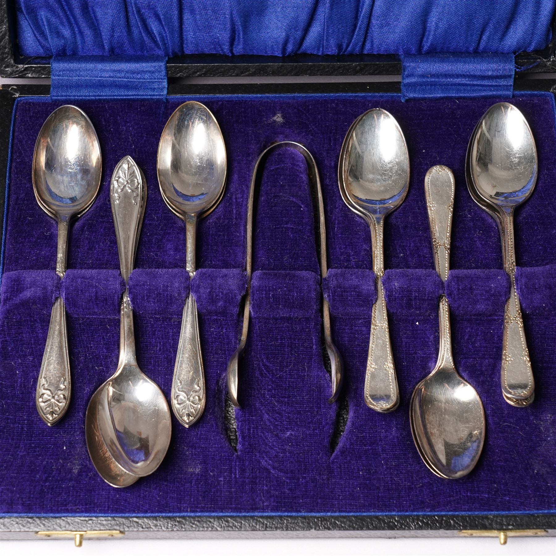 Set of  of six silver coffee spoons and tongs with bright cut decoration Sheffield 1908 Maker Cooper Bros. and another set of six coffee spoons with decorative terminals