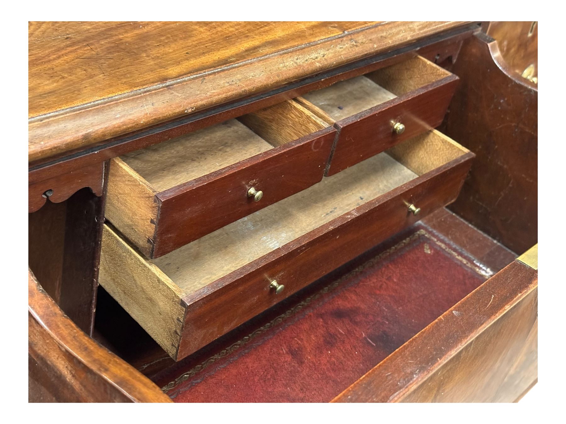 George III mahogany bookcase secretaire, dentil cornice over blind fret work frieze, enclosed by two astragal glazed doors, central secretaire drawer with fall front enclosing leather writing surface and small drawers, two flanking short drawers over double cupboard, on bracket feet