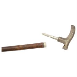 20th century novelty walking stick, the L-shaped metal handle as a whistle, bamboo cane, together with another novelty walking stick hardwood stick topped with a metal handle engraved A. Nutt, the top unscrewing to reveal an inner compartment containing a metal Irish flute, largest L96cm 