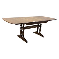 Ercol - late 20th century oak refectory dining table, rectangular top with rounded corners and central extending leaf, raised on turned baluster supports united by a stretcher (Extended 200cm)