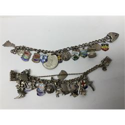 Four charm bracelets, with charms including animals and enamel country and towns, scarecrow, gun and some silver examples