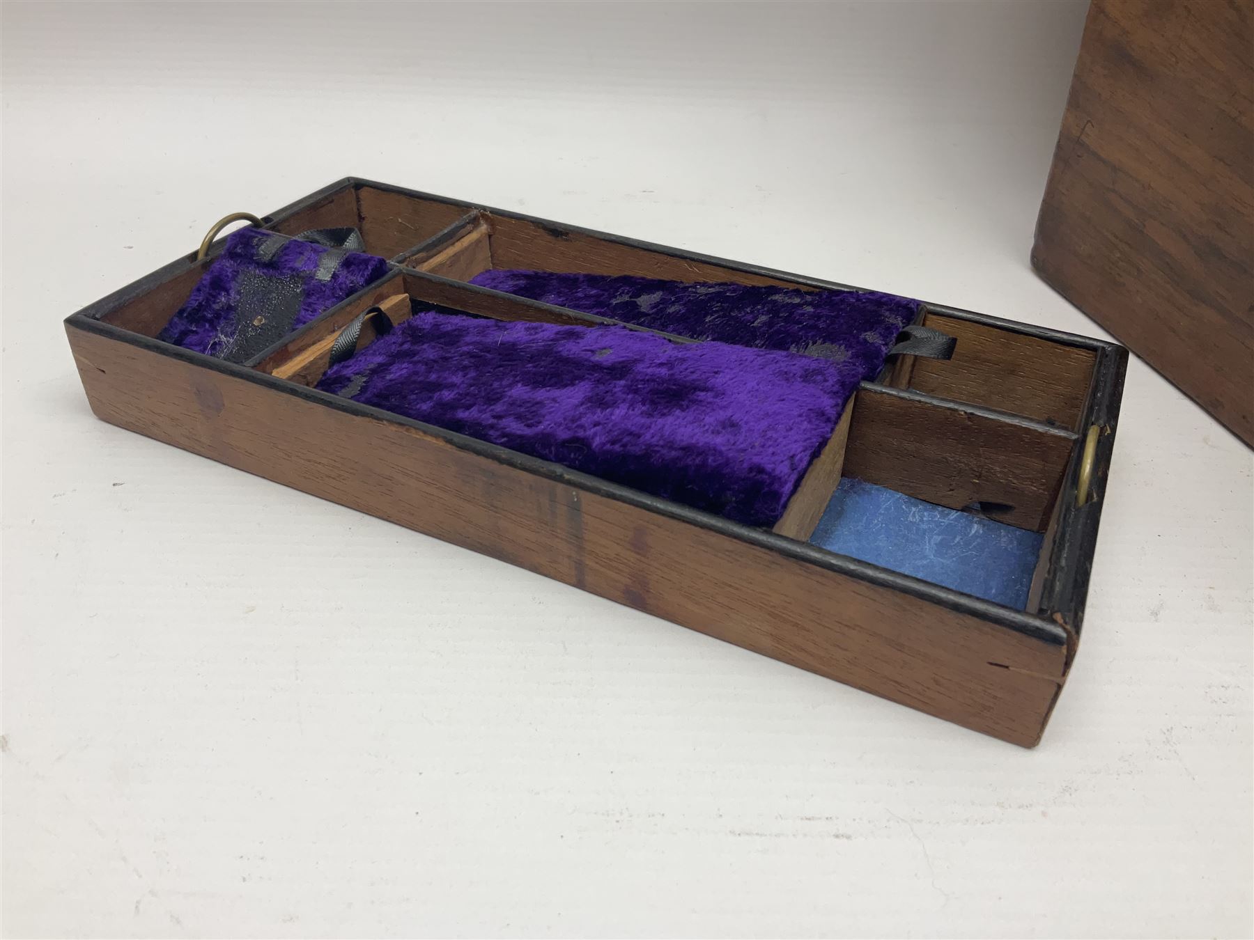 Walnut dressing table box, set with mother of pearl cartouche, opening to reveal a compartmentalised interior with mirror, covered in parts in purple velvet, together with a smaller jewellery box with stencil print, dressing table box H15cm