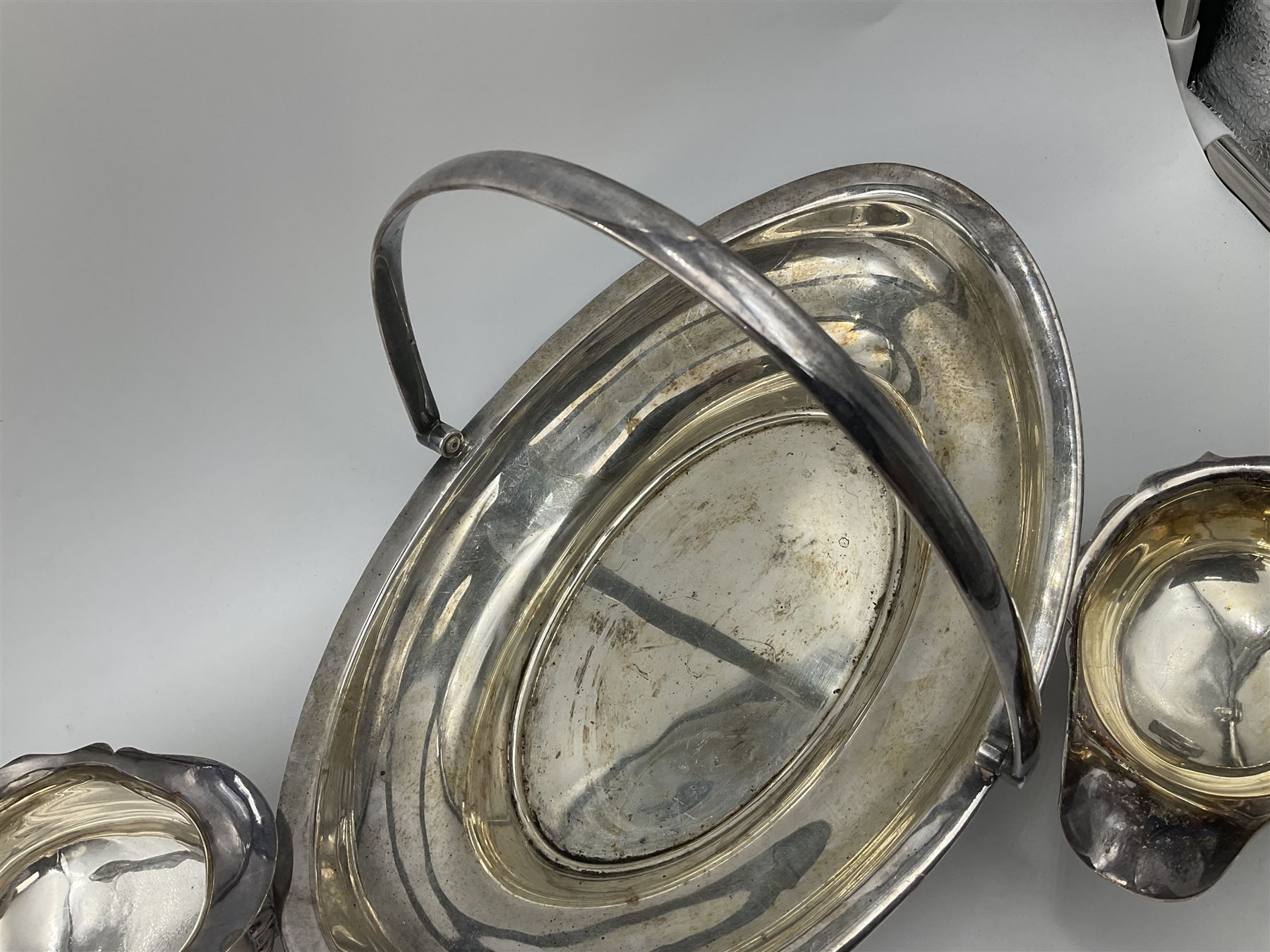 Silver plated seven bar toast rack by Mappin & Webb, together with other silver plated items including pair of bottle coasters, swing handled baskets and two sauce boats