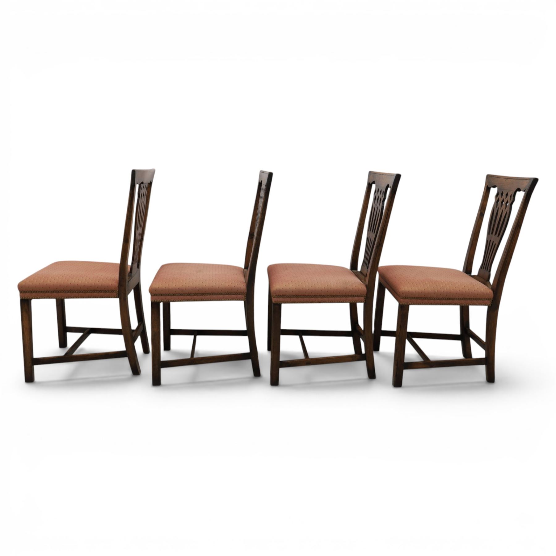 Set of eight George III dining chairs with padded seats, pierced vasiform splat, upholstered seat with brass trim, on square supports with H-stretcher