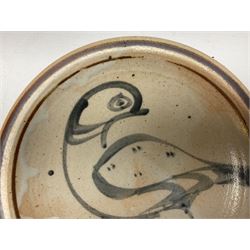 Studio pottery bowl, probably by Svend Bayer of Wenford Bridge, the stoneware body of shallow circular footed form with brushwork decoration of a stylised bird figure in grey upon peach ground within bands of iron red, unmarked, D18.5cm