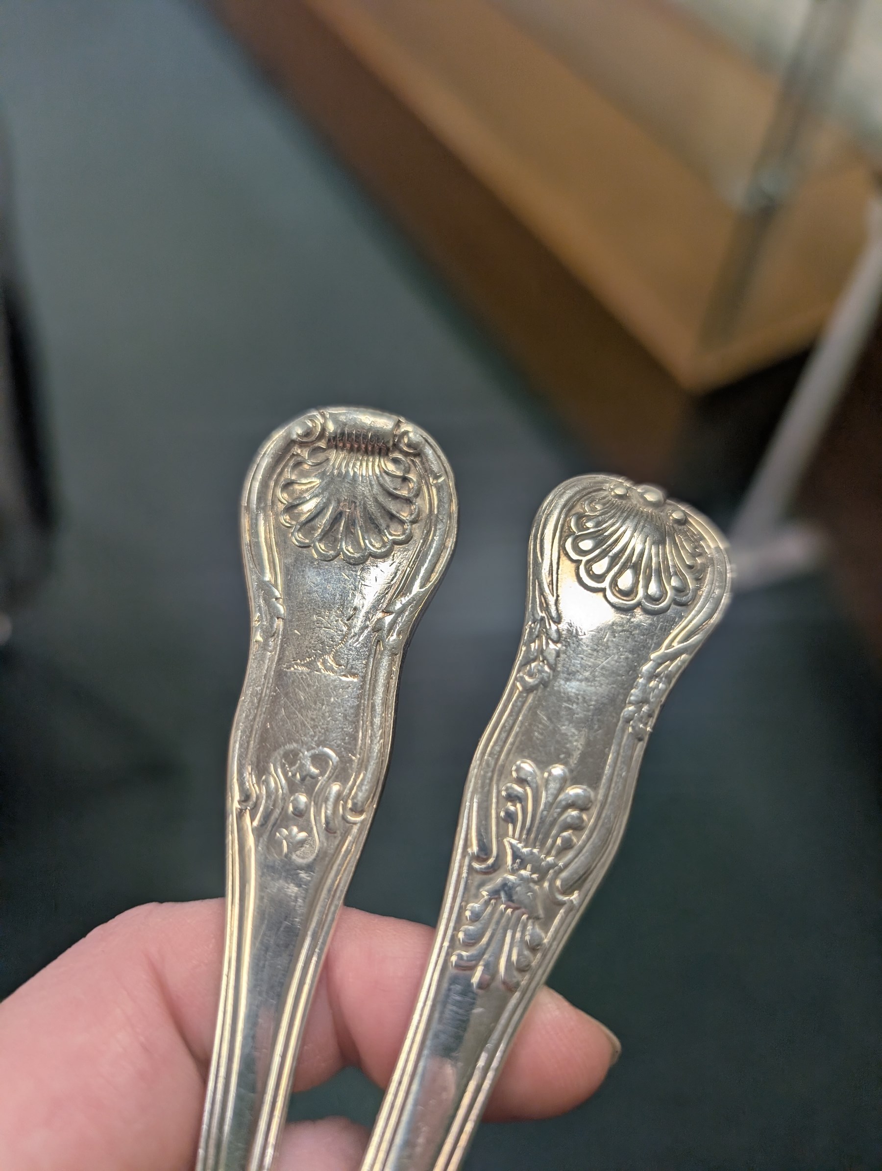 Seven silver Kings/Queens pattern dessert spoons, including George III Irish silver pair with engraved griffin crests, hallmarked Dublin 1818, maker's mark SI and five with varying dates and makers, all hallmarked 