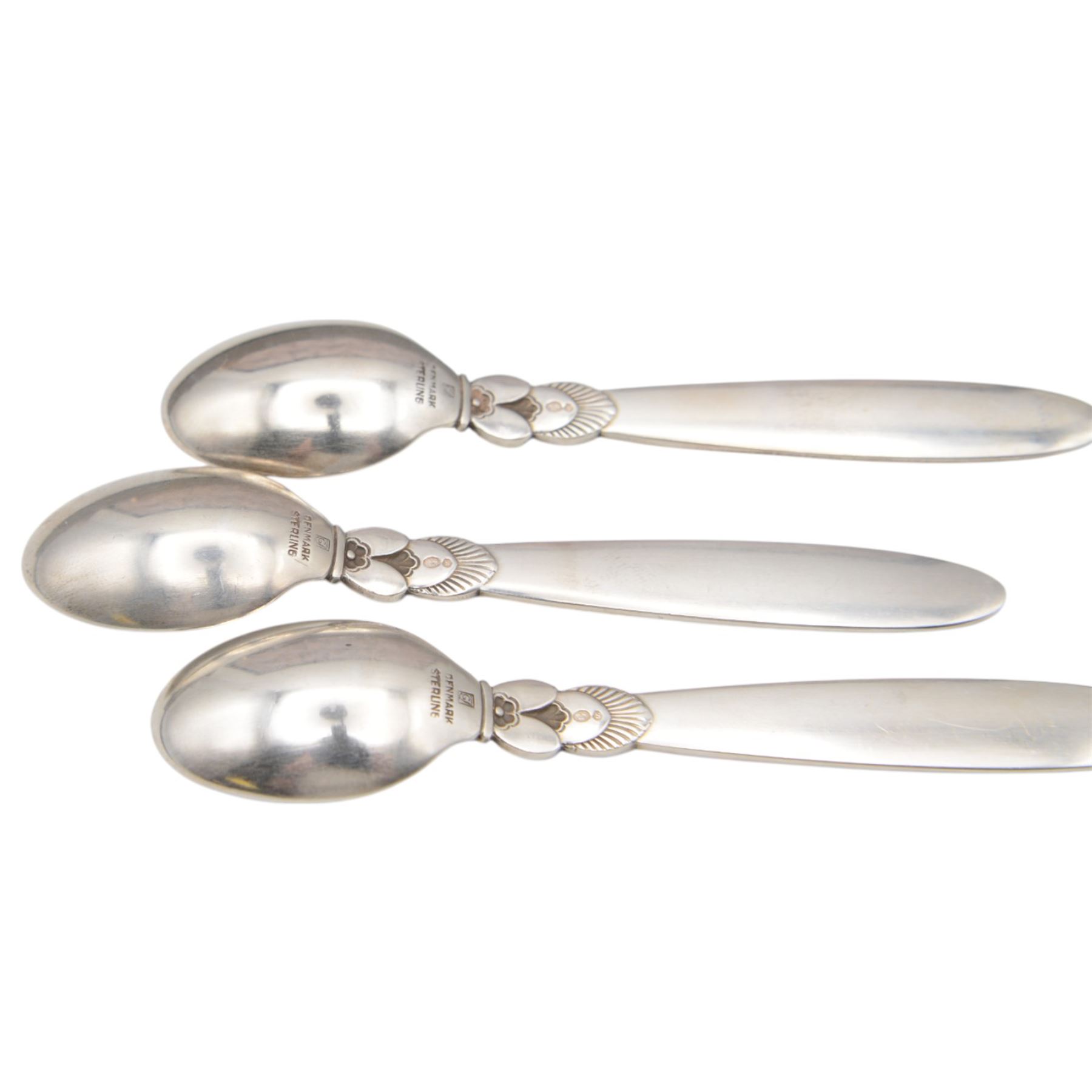 Set of twelve early 20th century Danish silver Cactus pattern demitasse spoons by Georg Jensen, marked for Georg Jensen, Denmark, also marked with Swedish national control mark and S standard mark for minimum 800 standard silver, contained within tooled leather David Andersen case with silk interior