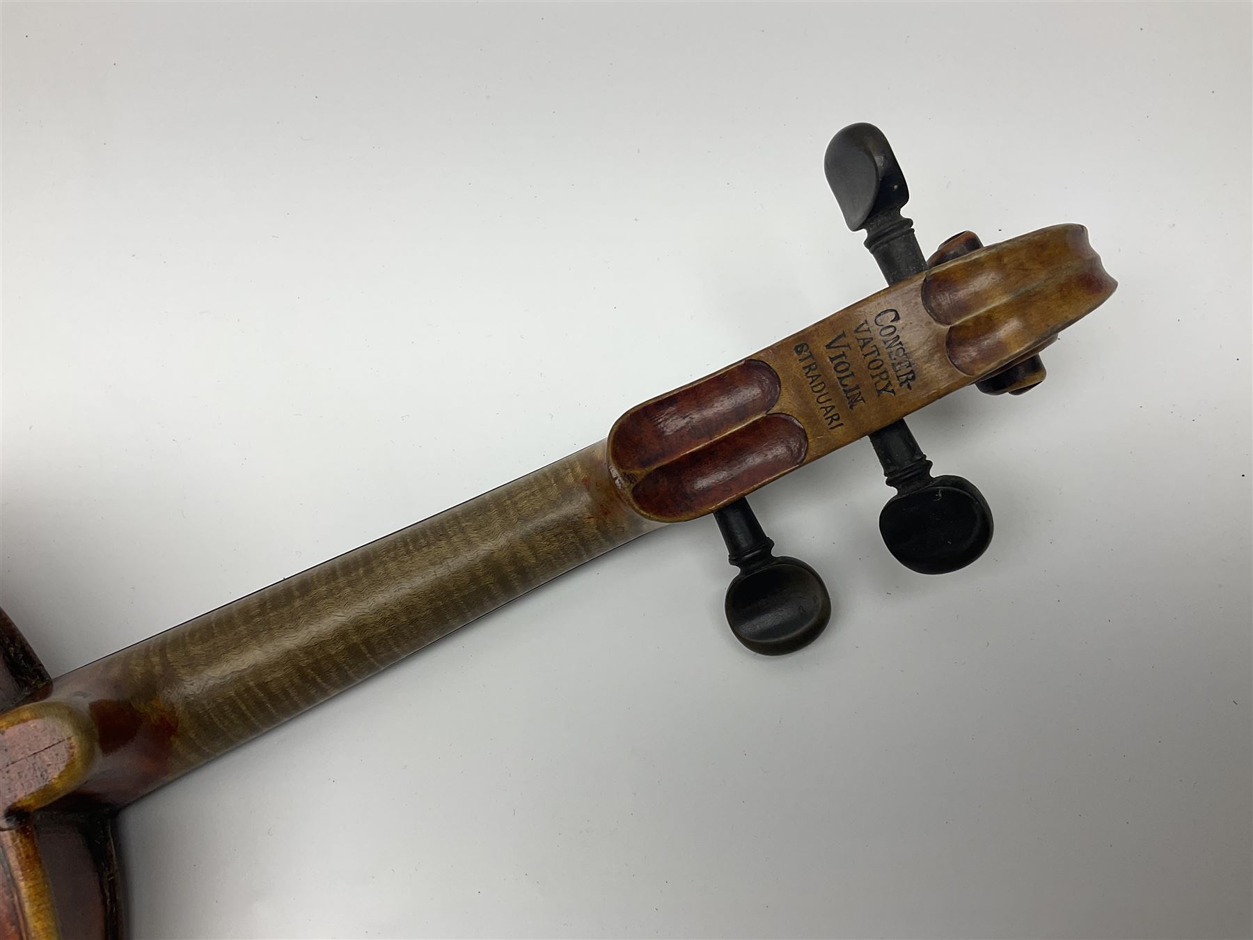 Late 19th century French three-quarter size 'Conservatory' violin with 34cm two-piece maple back and ribs and spruce top, the peg box inscribed 'Conservatory Violin Straduari', bears label 'Antonius Stradiuarius Cremonensis Faciebat Anno 1721' L55.5cm overall; in ebonised wooden 'coffin' case; and Saxony violin c1900 with 36cm two-piece maple back and ribs and spruce top; bears label 'Antonius Stradivarius Cremonensis Faciebat Anno 17**' L59cm overall; in carrying case (2)