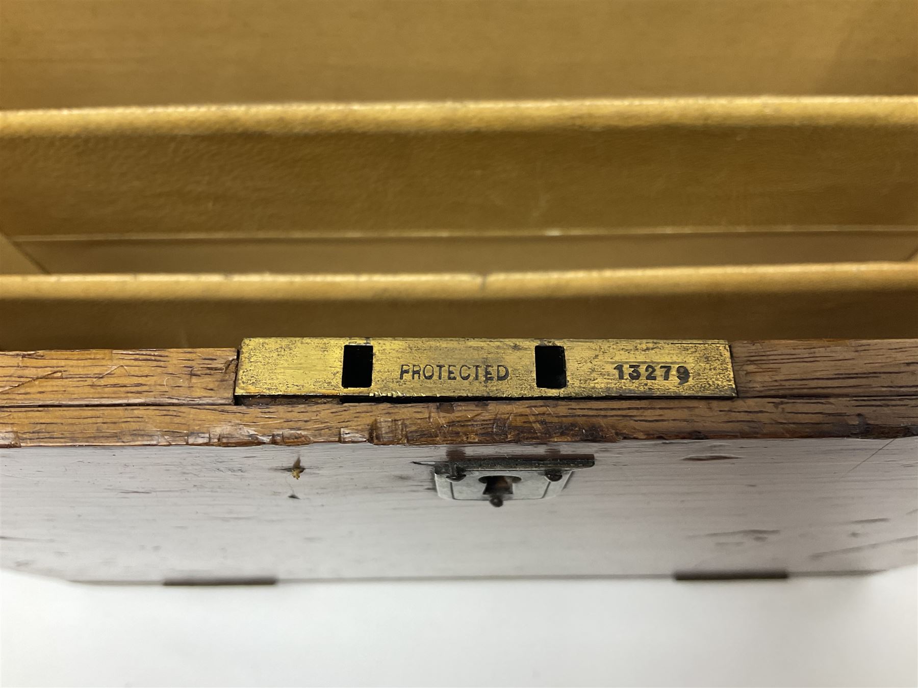 Wooden table stationery box, with drop down front and fitted interior, with metal shield plaque to the hinged lid, H18cm