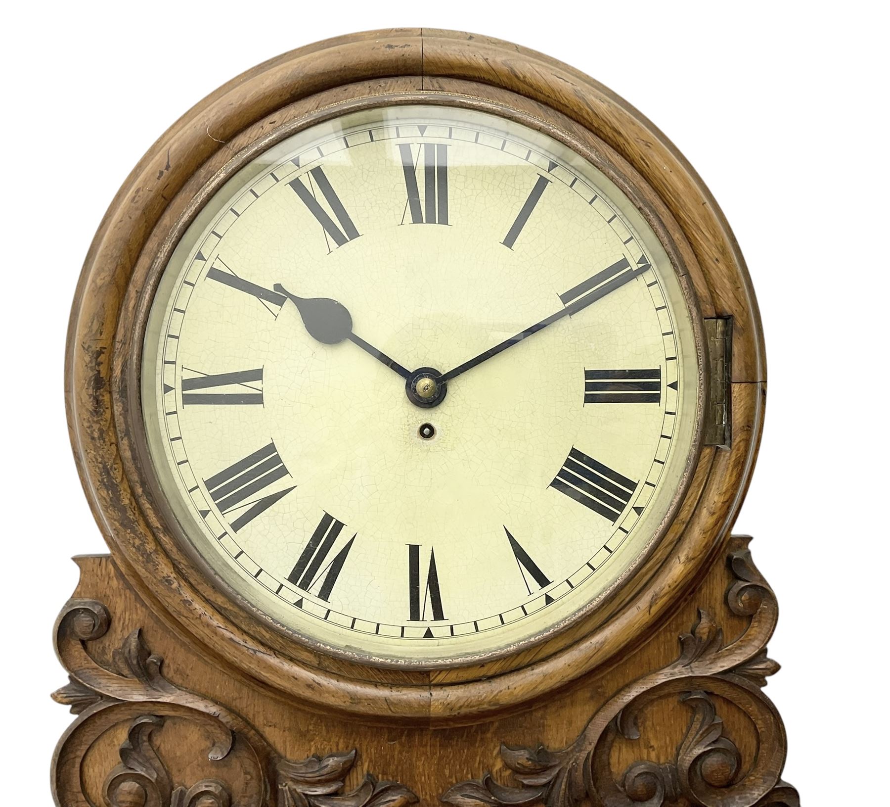 Winterhalter and Hoffmeier -  German oak cased early 20th century fusee wall clock, with a circular wooden surround and a spun brass glazed bezel to the dial, housed on an integral carved bracket with shaped corbel supports, painted dial with Roman numerals, minute track and steel spade hands, dial pinned directly to a four pillar chain driven fusee movement with a recoil anchor escapement. With pendulum and key. 
German fusee movements by Winterhalter and Hoffmeier are comparatively rare, especially housed in carved wall clocks of this description. 
