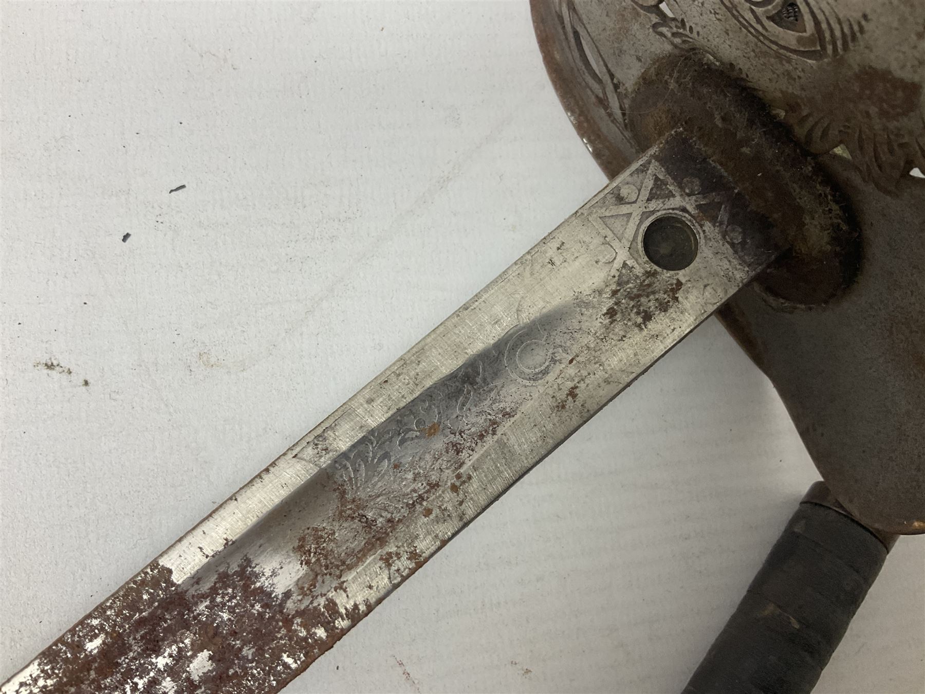 George V 1897 pattern Infantry officers sword, the 82cm single fullered blade with traces of etched detail and George V crown cipher, the ricasso marked Hawksworth Sheffield, pierced half basket hilt with George V cypher, wire-bound fish-skin grip with brass pommel and backstrap; in leather scabbard L102cm overall; together with two sectional gun cleaning rods; swagger stick made of leather strips etc