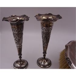 Early 20th century silver vase, of waisted form, with reed and bow border, upon knopped stem and filled circular stepped foot, hallmarked William Comyns & Sons, London 1911, H15cm, together with pair of Indian silver trumpet vases, with chased and embossed floral decoration, a pair of silver mounted clothes brushes, hallmarked Deakin & Francis Ltd, Birmingham 1946  and a 1920s silver mounted hairbrush, hallmarked W J Myatt & Co, Birmingham 1922