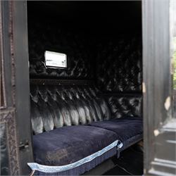 Town Coach by John Marstons Birmingham - Ex Film

A black painted five glass Town Coach by John Marston's Carriage Works Ltd, Birmingham, with enclosed glazed passenger compartment, curved front glass, external coachman's box seat and pole for driving with a pair of horses. The carriage has a timber coach body with buttoned black leather interior, blue upholstered seat cushions, plated exterior door handle, maker plates to the body and step, and John Marston marked hub caps. Mounted on black painted wooden spoked wheels with rubber tyres, leaf spring suspension, underbody turntable steering and iron fittings throughout.
Featured on the film set of 'Victoria' with Jenna Coleman

Features

• Black painted enclosed coach body
• Glazed passenger compartment with five windows
• Curved front glass
• Buttoned black leather interior
• Blue upholstered seat cushions
• External coachman's box seat
• Timber coach body
• Wooden spoked wheels
• Rubber tyres
• Leaf spring suspension
• Underbody turntable steering
• Pole for pair of horses
• Iron foot steps
• Plated exterior door handle
• Maker plates for John Marston's Carriage Works Ltd, Birmingham
• John Marston marked hub caps
• Featured on the film set of Victoria with Jenna Coleman

Dimensions:
Overall length: 390 cm
Width: 190 cm
Height: 214 cm

Wheel Diameters:
Front wheels: 104 cm
Rear wheels: 134 cm

Seating:
Coachman's box: 2
Passenger compartment: 4