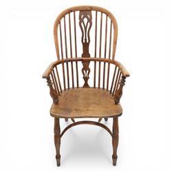 Early 20th century yew wood Windsor armchair, hooped back with spindle supports and shaped pierced central splat, solid seat with shaped edge, turned arm supports, on turned legs united by crinoline stretcher