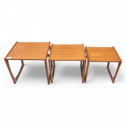 G-Plan - mid 20th century nest of three teak tables, rectangular tops with rounded edges, supported by sculptural open sided frames