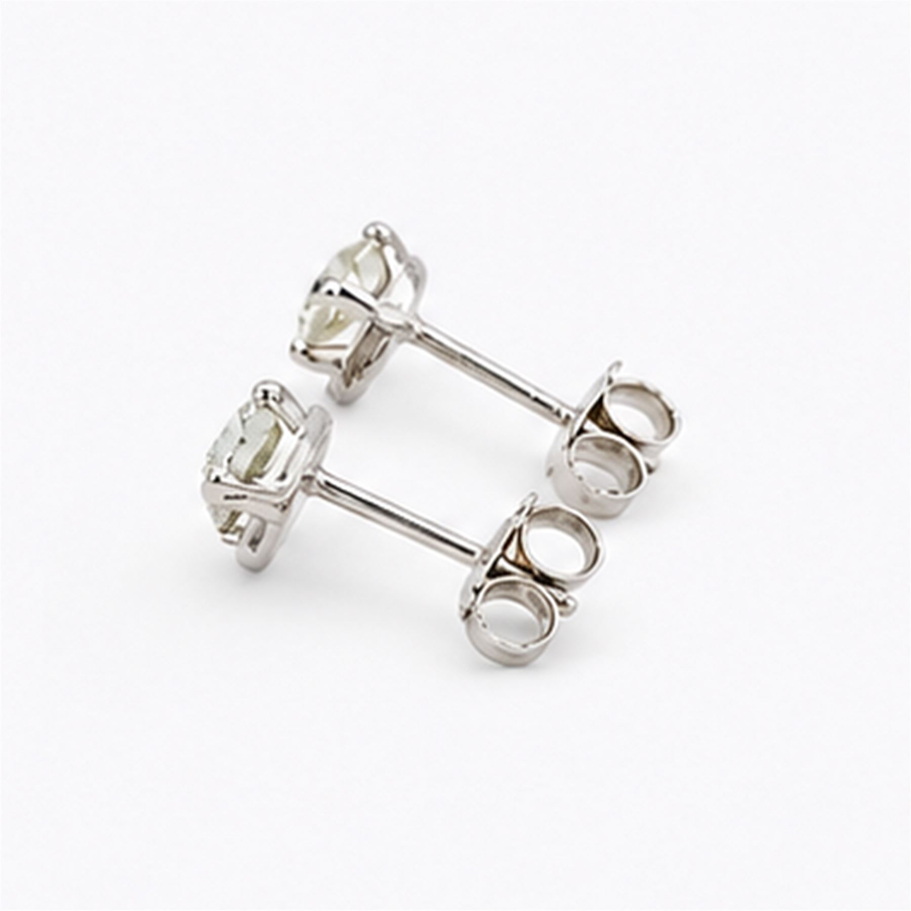 Pair of 18ct white gold diamond earrings, each stud set with a single round brilliant cut diamond, stamped 750, total diamond weight approx 1.00 carat