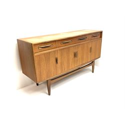 G-Plan teak sideboard, central long drawer above double cupboard door, flanked by short drawer and single cupboard enclosing shelving, shaped supports and stretcher 