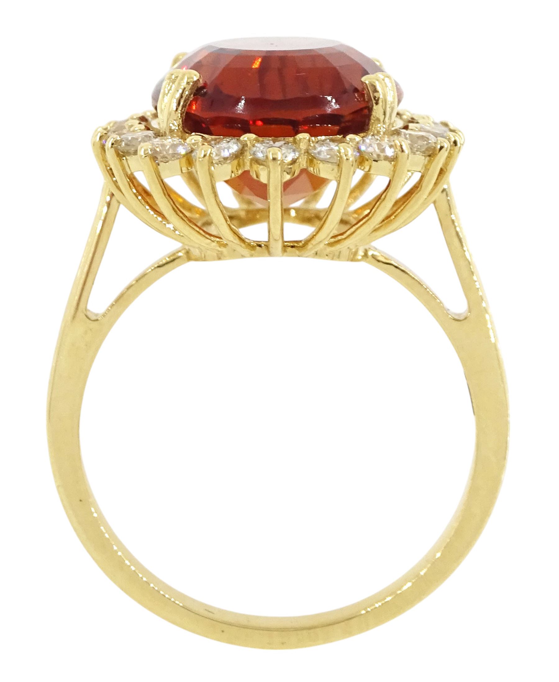 18ct gold citrine and diamond cluster ring, single oval cut citrine of approx 7.35 carat, with round brilliant cut diamond surround, stamped, total diamond weight approx 0.75 carat