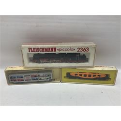 'N' gauge - Fleischmann Piccolo 2363 DB 2-10-0 locomotive; Minitrix 2932 DB double pantograph electric Co-Co locomotive; Atlas 2112 0-8-0 Indiana Harbor Belt locomotive No.102; all boxed; two passenger coaches; boxed crane wagon; car transporter, tank transporter and other goods wagons, various makers predominantly unboxed