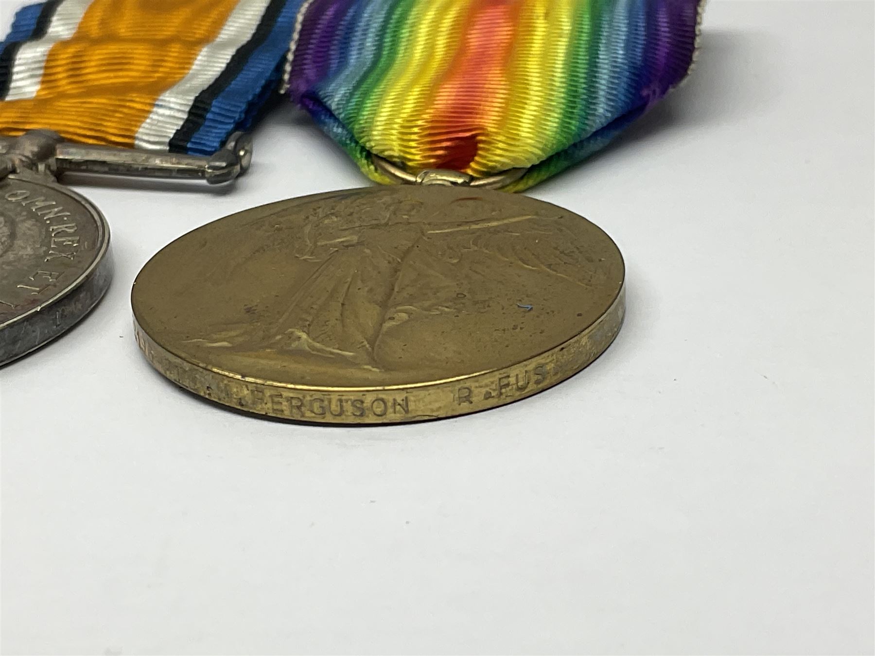 WWI pair of medals comprising British War Medal and Victory Medal awarded to G/62196 Pte. H. Ferguson R. Fus. with ribbons on wearing bar; together with bronze memorial plaque to Henry Ferguson (3)