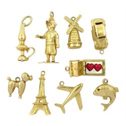 Nine 14ct gold pendant / charms including poodle dog, windmill, car, fish, aeroplane, Eiffel Tower and house