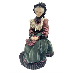 Anna Meszaros Hungary - hand made needlework finely detailed figurine of a pensive old lady seated on a stool wearing a lace trimmed long black and maroon dress and hat, clutching a lace bag H32cm Auctioneer's Note: Anna Meszaros came to England from her native Hungary in 1959 to marry an English businessman she met while demonstrating her art at the 1958 Brussels Exhibition. Shortly before she left for England she was awarded the title of Folk Artist Master by the Hungarian Government. Anna was a gifted painter of mainly portraits and sculptress before starting to make her figurines which are completely hand made and unique, each with a character and expression of its own. The hands, feet and face are sculptured by layering the material and pulling the features into place with needle and thread. She died in Hull in 1998.