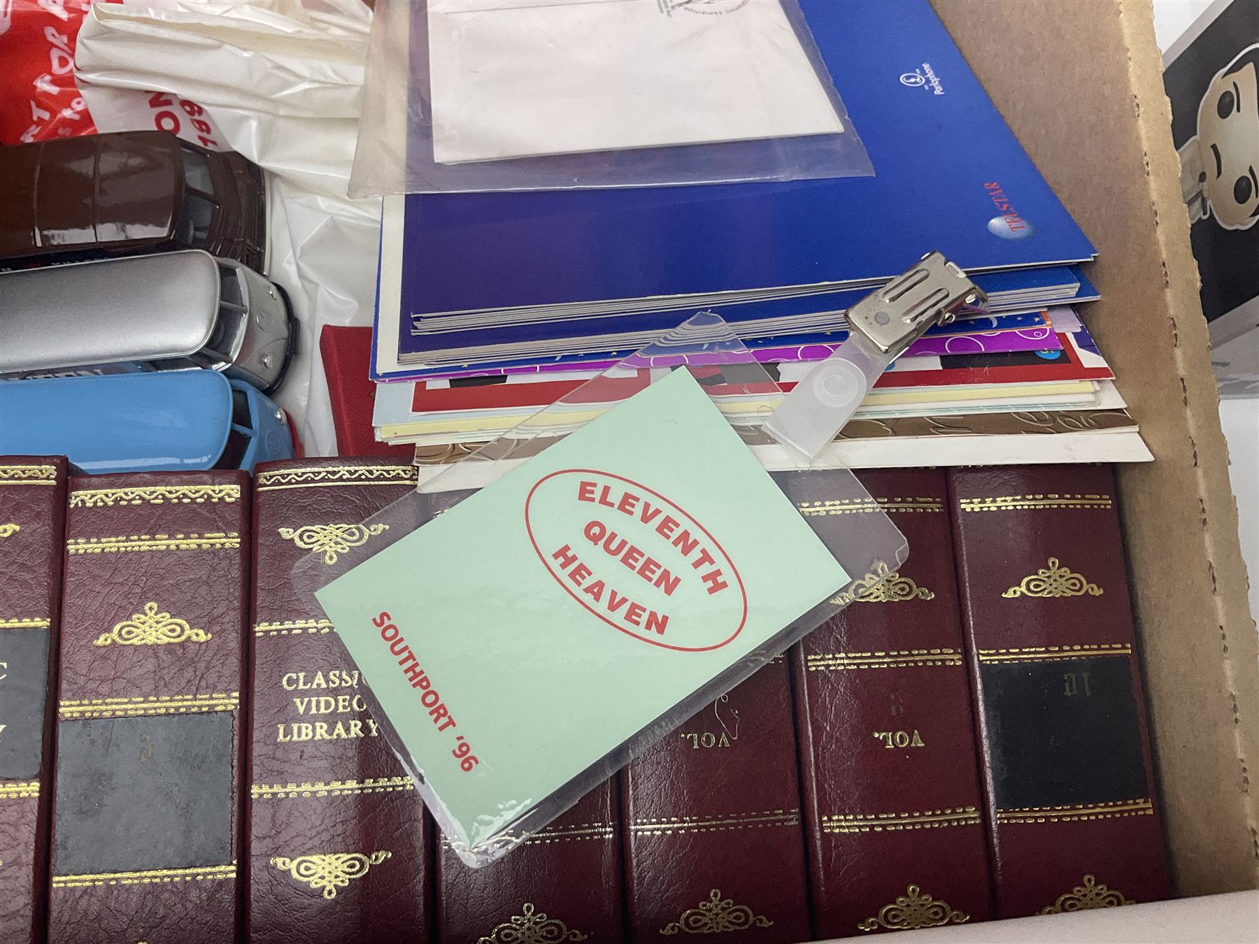 Mostly Queen and Freddie Mercury interest items, including pin badges, newspaper cuttings, diecast 'promotional' vehicles, special edition Pop Rocks figure of Freddie Mercury, VHS tapes, two charity certificates signed by Brian May and Roger Taylor, poster etc, in two boxes 