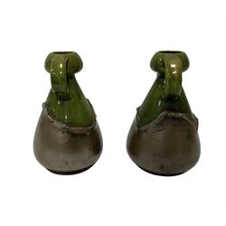 Pair of early 20th century Bretby Arts and Crafts style twin handled vases with green and copper glaze, with impressed marks beneath