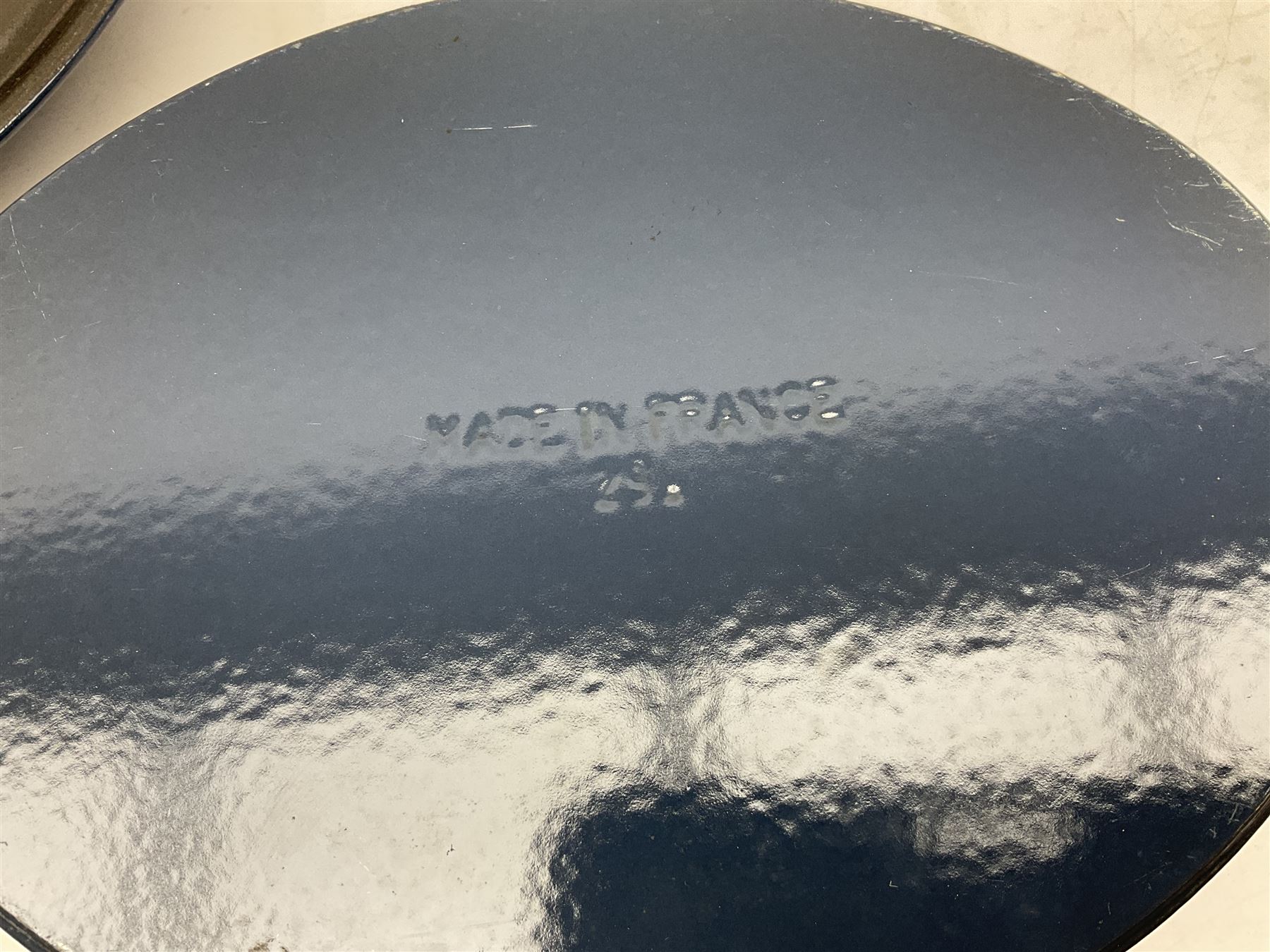 Emile Henry covered casserole dish of oval form in two tone brown and cream, no. 03.06, together with cast iron Nomar twin handled lidded casserole dish of oval form in navy, and other ovenware including Flintware ICTC, largest L35cm