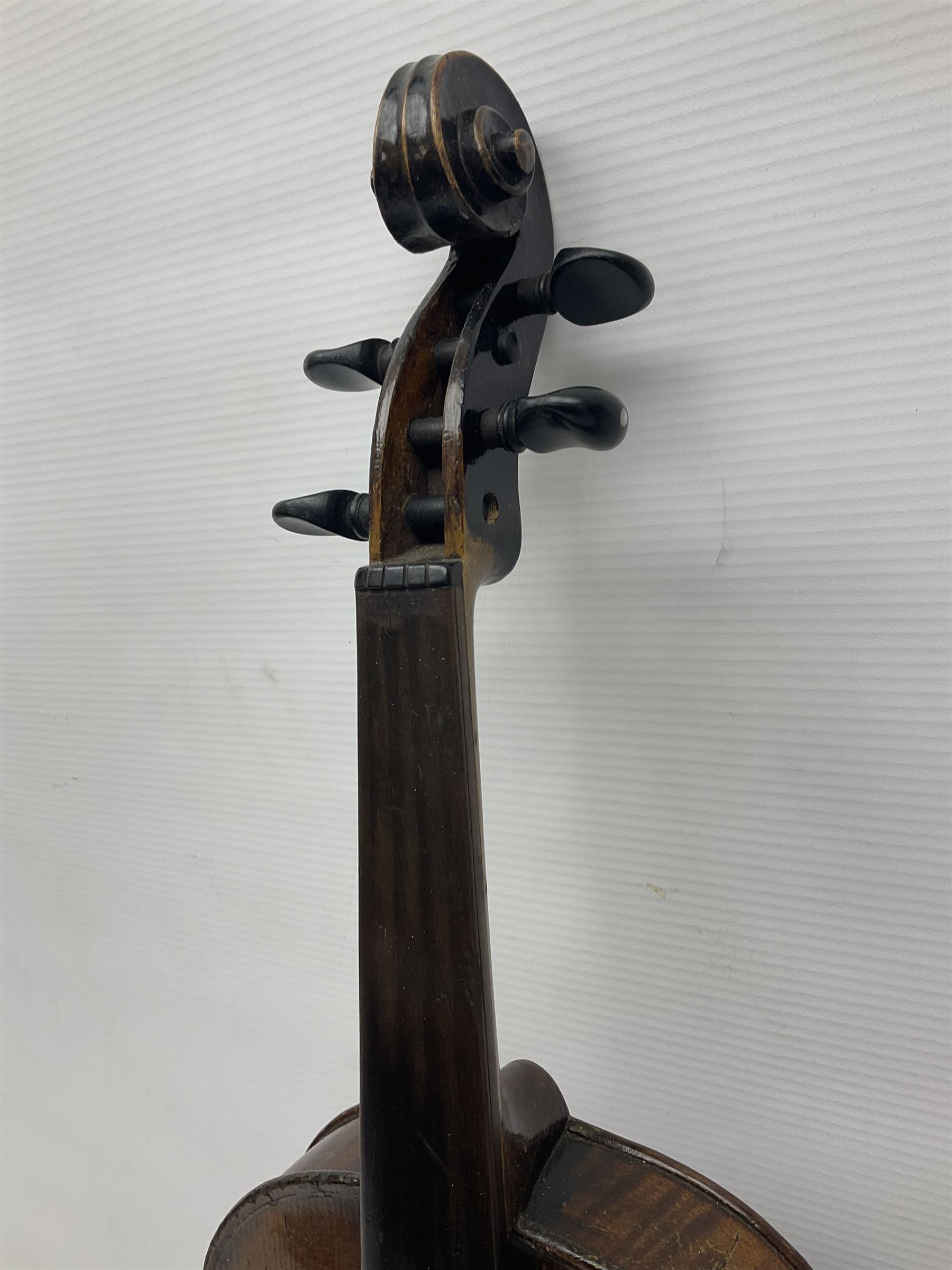 German violin c1890 with 36cm two-piece maple back and ribs and spruce top; bears label 'Antonius Stradivarius Cremona Faciebat Anno 1729' L59.5cm overall; in ebonised wooden 'coffin' case; and two German violins c1890 for completion - one bearing a Stradivarius label, the other a Ruggeri label; both in carrying cases (3)