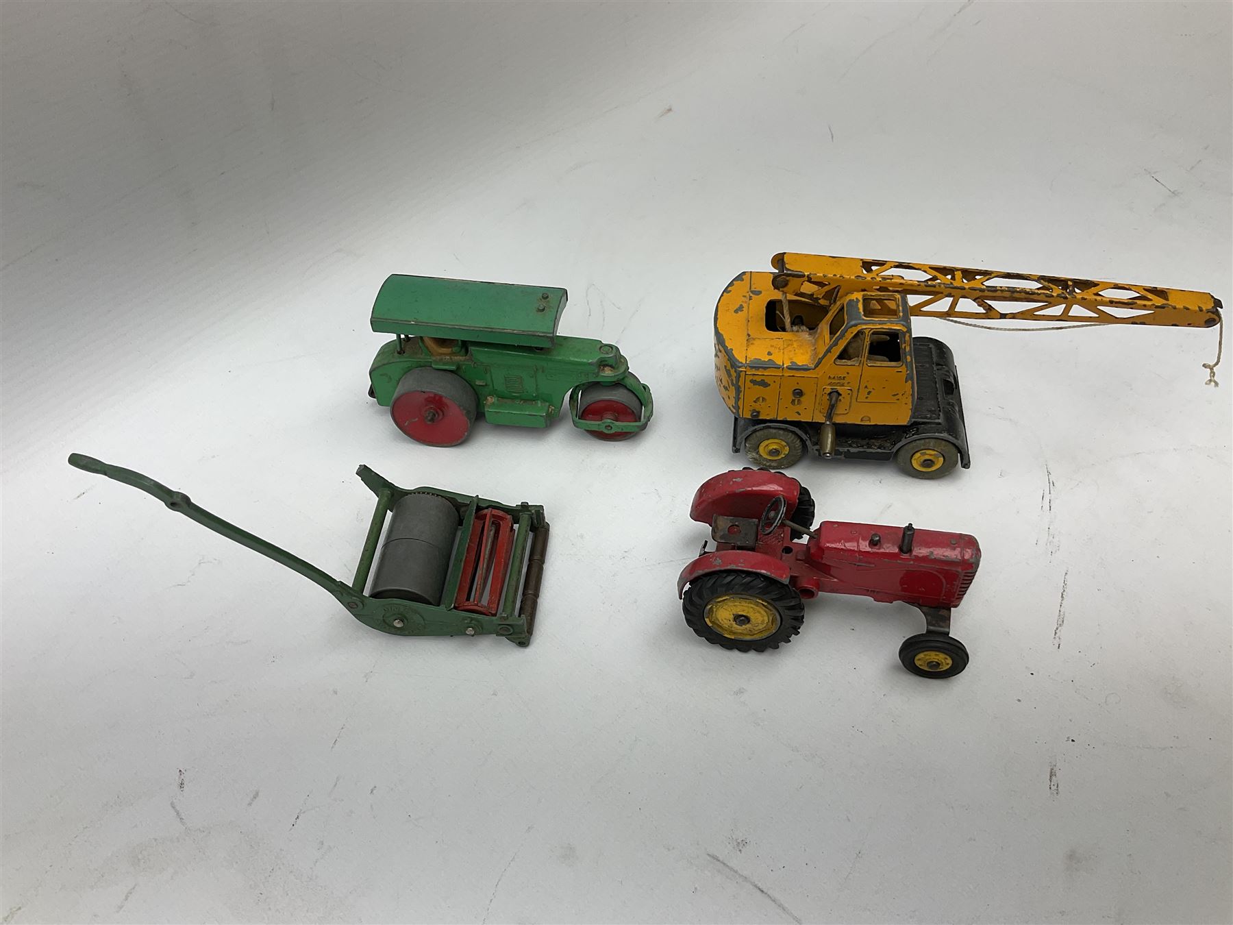Dinky - nineteen unboxed and playworn/repainted die-cast models including Muir Hill Dumper, Muir Hill 2WL and Heavy Tractor; all repainted; Coles Mobile Crane, two Aveling-Barford steam rollers; Massey-Harris tractor and manure spreader; Land Rover; nine various trailers etc (19)