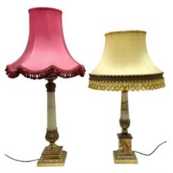 Two heavy oynx and brass mounted table lamps, with acanthus capped tapering columns raised upon square stepped bases with foliate decoration, both with tasselled fabric shades, tallest H97cm incl shade