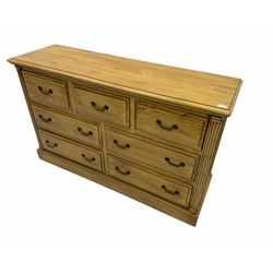 Polished pine chest, fitted with seven drawers