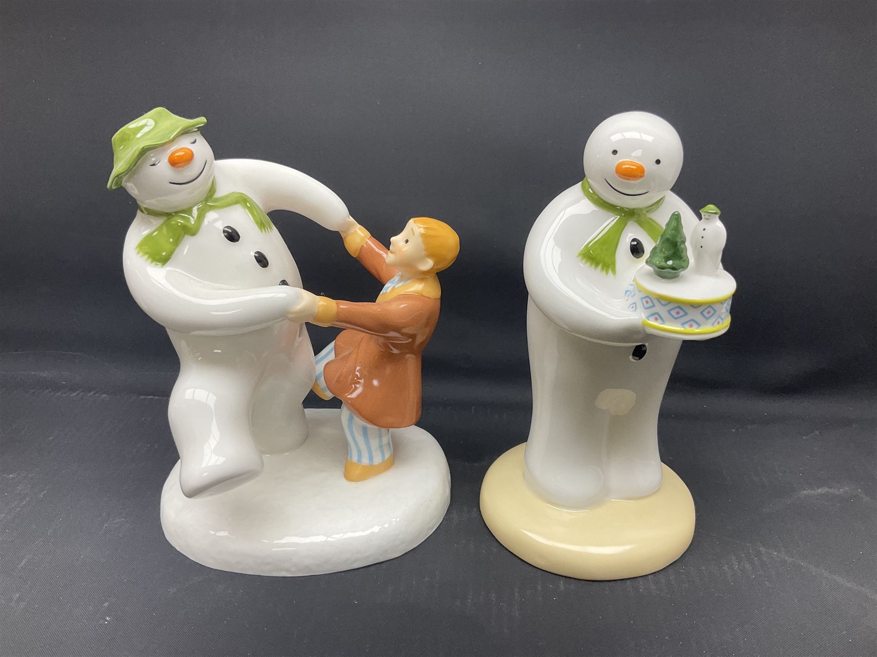 Four Coalport Characters The Snowman figures, comprising Snowman's Surprise, Christmas Cheer with certificate, The Bashful Blush and Dancing at the Party, all with original boxes 
