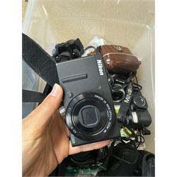 Collection of cameras and camera equipment, including Voigtlander Vitomatic I, Nikon Coolpix P340, Nikon Coolpix S9100, Olympus SP-510UZ, tripod, cases, etc