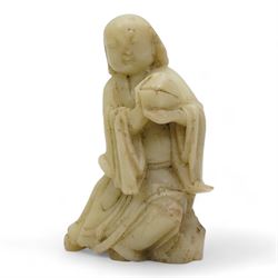 Chinese blanc de Chine figure of Guanyin, wearing robes and standing upon a lotus base, H25.5cm, a jichimu carved wooden stand, and carved greenstone figure of an immortal (3)