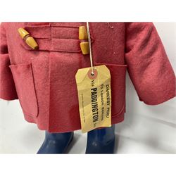 Pair of Paddington Bear teddies with amber eyes, the first example having a brown felt hat, red coat and blue PB boots with original label; the second having a grey felt hat, blue coat and blue Dunlop boots, tallest H51cm 