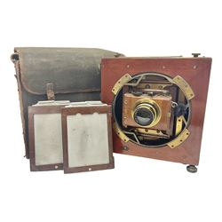 Folding plate camera in mahogany and lacquered brass, with Rapid Symmetrical Reetigmat len and two dark slides in canvas case