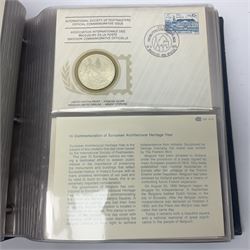 Thirty-one 'International Society of Postmasters Official Commemorative Issues' sterling silver proof medallic covers dating from 1975 to1977, housed in the official folder and a 'Commemorating The Bicentennial Of The United States Of America' sterling silver proof medallic first day cover in blue wallet