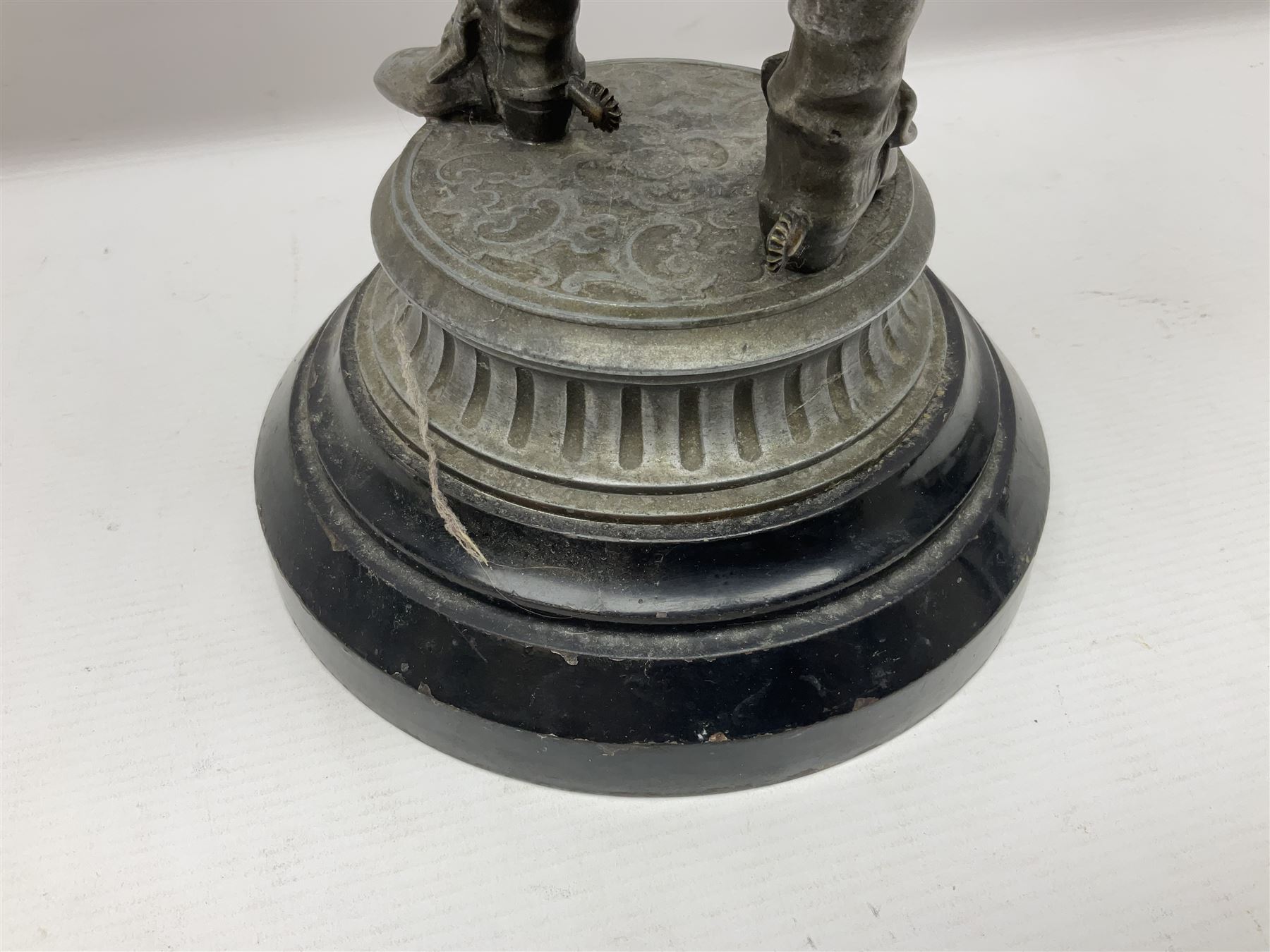 Spelter figure modeled as Cavalier with a raised sword, upon a circular base, H52cm