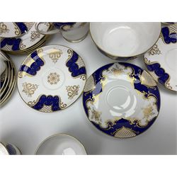 Shelley Empire pattern tea service for twelve, decorated with borders of electric blue and gilt foliate design on plain white ground, pattern no 14078, comprising fourteen saucers, fourteen tea plates, cake plate, twelve teacups, teapot, bowl and jug, all with printed marks beneath