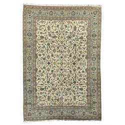 Persian Kashan carpet, light sage green ground, the field decorated all-over with interlaced foliate and plant motifs, repeating scrolled border with stylised flower head motifs