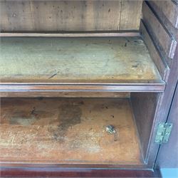 Early 19th century figured mahogany bureau bookcase, projecting splay moulded cornice over three adjustable shelves enclosed by two glazed doors, fall front revealing pigeonholes, cupboard and drawers, pull-out strays with scroll carved terminals, double cupboard with two panelled doors, on turned feet 