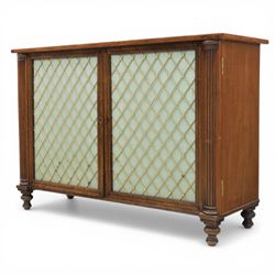 Late 20th century Regency style mahogany side cabinet, the rectangular crossbanded top with ebonised line inlay, above a pair of brass lattice grille doors with pale green fabric backing enclosing a shelved interior and two frieze drawers, flanked by reeded corner pilasters, upon turned tapering feet