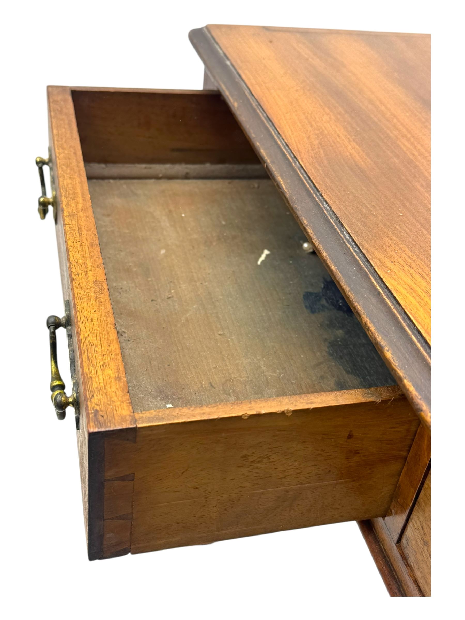 Early 19th century mahogany side table, moulded rectangular top over two drawers, on turned and reeded supports, brass cups and castors 