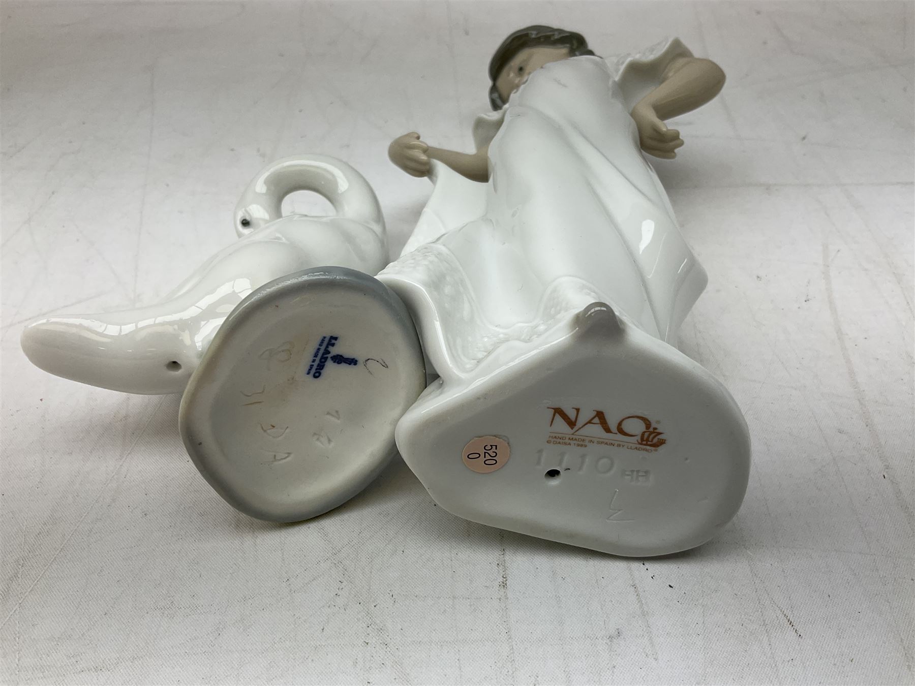 Quantity of figures to include Lladro example modelled as swan together with three Nao figures to include two April Showers no 1126, two with boxes 